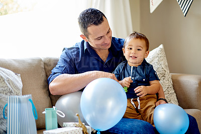Buy stock photo Father, son and smile with party for birthday, childhood or bonding on sofa in home. Dad, child and portrait for celebration, love and fun in living room of house for event together with presents