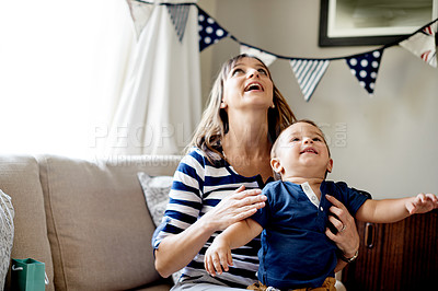 Buy stock photo Birthday party, mother and son with smile, home and celebration with happiness, love and family. Apartment, parent and mama with boy, event and looking up with care, bonding together or kid in lounge