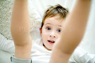 Buy stock photo Portrait, playful and kid in house with freedom, relax and child wellness in morning fun. Above, youth and boy in bedroom with pillow, happy moment and childhood development on weekend break.