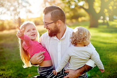 Buy stock photo Happy, dad and bonding with children, park and man with girls, point and scenery on summer vacation. Outdoor, father and break with daughters, family and flare on holiday, love or affection in nature