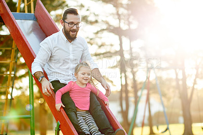 Buy stock photo Nature, slide and father with kid in park for holiday, weekend or vacation together. Smile, trees and girl child with dad for playing outdoor on playground for connection or bonding in summer.