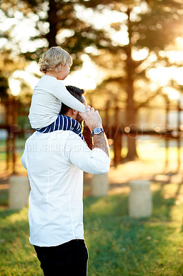 Buy stock photo Back, father and child on shoulder at park for travel, playful fun and bonding together on holiday. Man, walking and carry toddler with love, balance support and vacation with games to explore nature