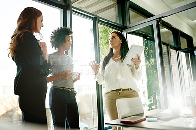 Buy stock photo Business women, tablet and team discussion in meeting for review, update or news report. Technology, group and planning with editor in chief in office for feedback, creative journalism and flare