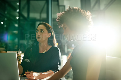 Buy stock photo Women, meeting and laptop at office, night and discussion with review, insight and planning at media company. People, editor or team with documents, flare or feedback with computer at creative agency