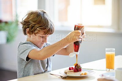 Buy stock photo Child, pancakes and breakfast in kitchen with syrup, meal prep and excited for eating. Happiness, boy and fruit in home with food, snack and hungry in morning for growth and development in childhood