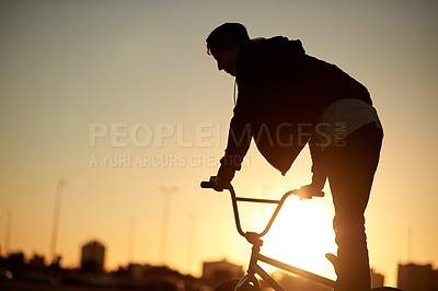 Buy stock photo Athlete, man and jump with bicycle at park for travel, tricks training and cardio exercise. Person, sunset and bike for fitness activity, sports workout and sustainable transport for stunt practice