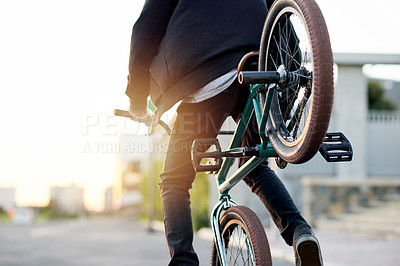 Buy stock photo Back view, city and person on bike for trick in street, flip for stunt or skill outdoor with extreme sports. Cyclist, rider and bicycle for urban challenge, performance or action in road at sunset