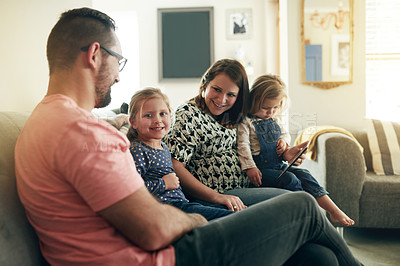 Buy stock photo Cute, portrait and smile of girl with family on sofa in living room of home for child development. Happy, love or security with mom, dad and daughter kids in apartment together for weekend bonding