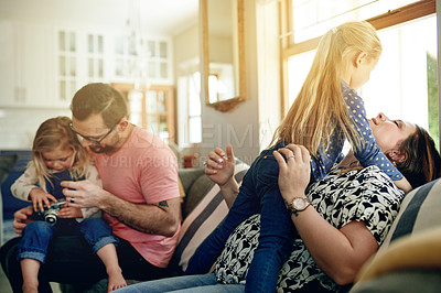 Buy stock photo Love, family time and parents with kids in lounge for bonding, play together and cozy weekend morning. Trust, caring man and woman with children in home for support, happiness and relationship.