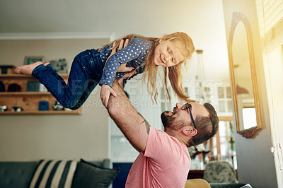 Buy stock photo Dad, girl and lift on sofa for airplane game, happy and bonding with love, care and connection in home. People, father and child with smile, fun or playful on couch in living room at family house