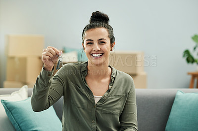 Buy stock photo Woman, smile and keys on sofa in new home with boxes, goals and real estate investment in living room. Person, excited and portrait on couch with fresh start, property or mortgage at house in Spain