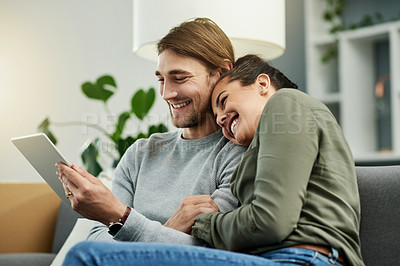 Buy stock photo Couple, laugh and watching movies on tablet, home and bonding with entertainment, online and lounge. Relax, woman and embrace with man in living room, subscription and tech for comedy film in house