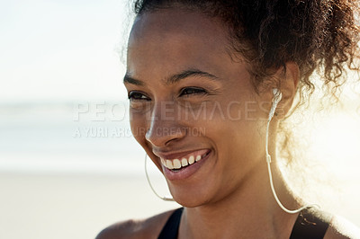 Buy stock photo Smile, athlete and woman with earphones at beach for fitness, listen to music and podcast. Thinking, female person and space with playlist audio for exercise, sports training and marathon practice