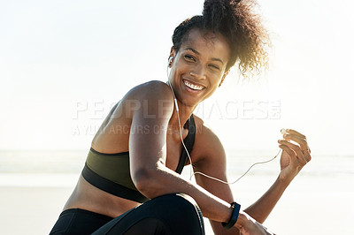 Buy stock photo Athlete, woman  and relax with earphones at beach of fitness, listening to music and podcast. Thinking, female person and smile with playlist audio for exercise, sports training and marathon practice