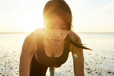 Buy stock photo Fitness, sunshine and woman on beach with push up, sunrise and commitment to healthy outdoor workout. Muscle, training and serious girl at ocean for morning exercise, wellness and body care in nature