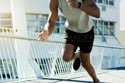 Buy stock photo Legs, black man and running for fitness in city for exercise, cardio training and endurance. Male person, athlete and speed for sports workout, marathon practice and race challenge for wellness