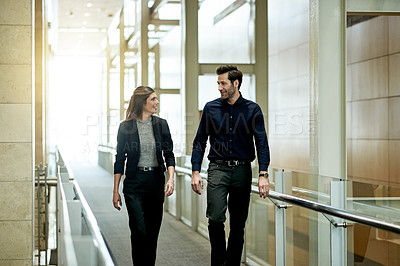 Buy stock photo Walking, office and business people in hallway talking for planning, feedback and meeting. Professional, corporate and woman with man in discussion for company networking, collaboration and coworking