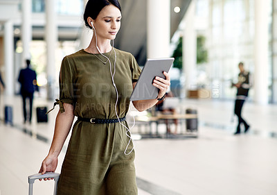 Buy stock photo Earphones, tablet and business woman in airport with suitcase for online meeting or contact. Digital technology, audio tech and female employee on virtual discussion with luggage for work trip.