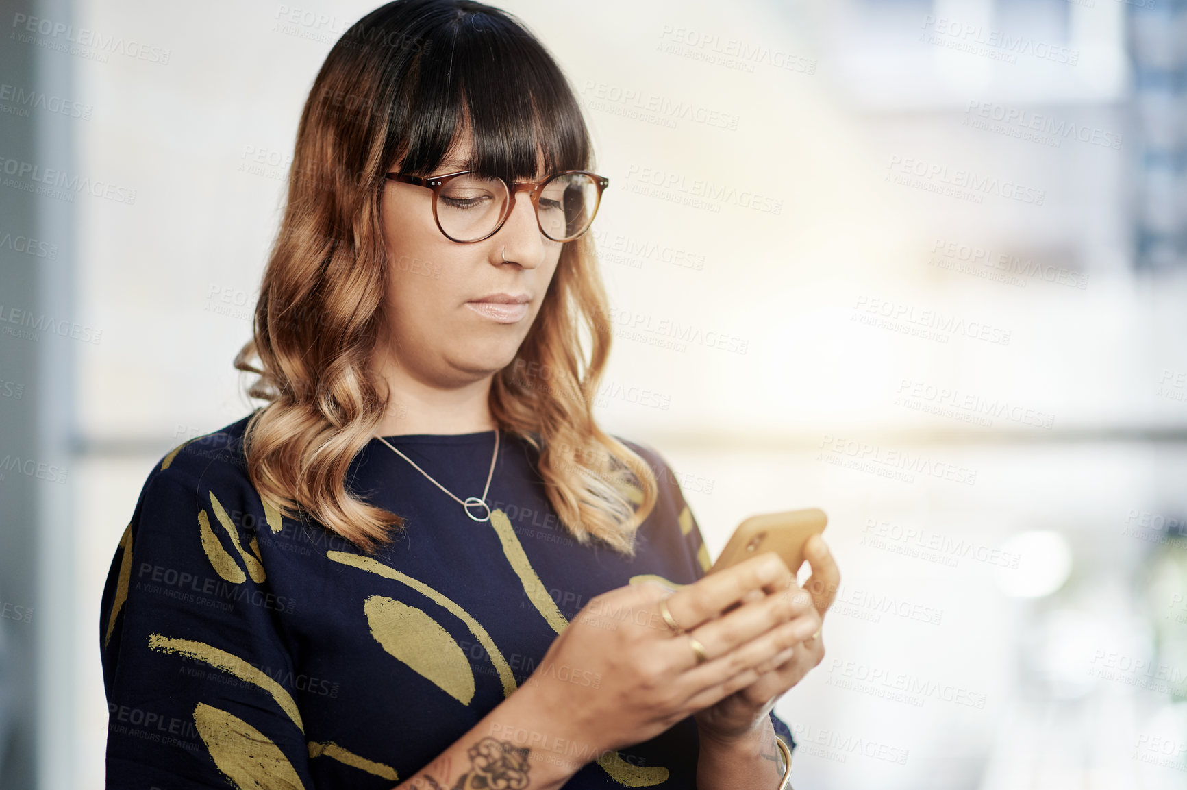 Buy stock photo Woman, phone and texting in office with contact, scroll and notification for story lead at media company. Person, smartphone and journalist with app for communication, research or article at agency