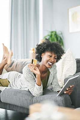 Buy stock photo Credit card, excited and black woman on tablet on sofa for online shopping, payment and digital order. Happy, home and person on tech with bank info for website sale, discount and ecommerce purchase