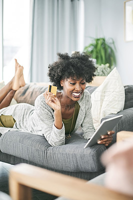 Buy stock photo Credit card, happy and black woman on tablet on sofa for online shopping, payment and digital order. Relax, home and person on tech with bank info for website sale, discount and ecommerce purchase