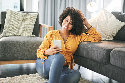 Buy stock photo Home, typing and woman with smartphone, smile and message to contact, humor and relax. Apartment, cellphone and happy person on carpet, funny meme and communication with connection and online comedy
