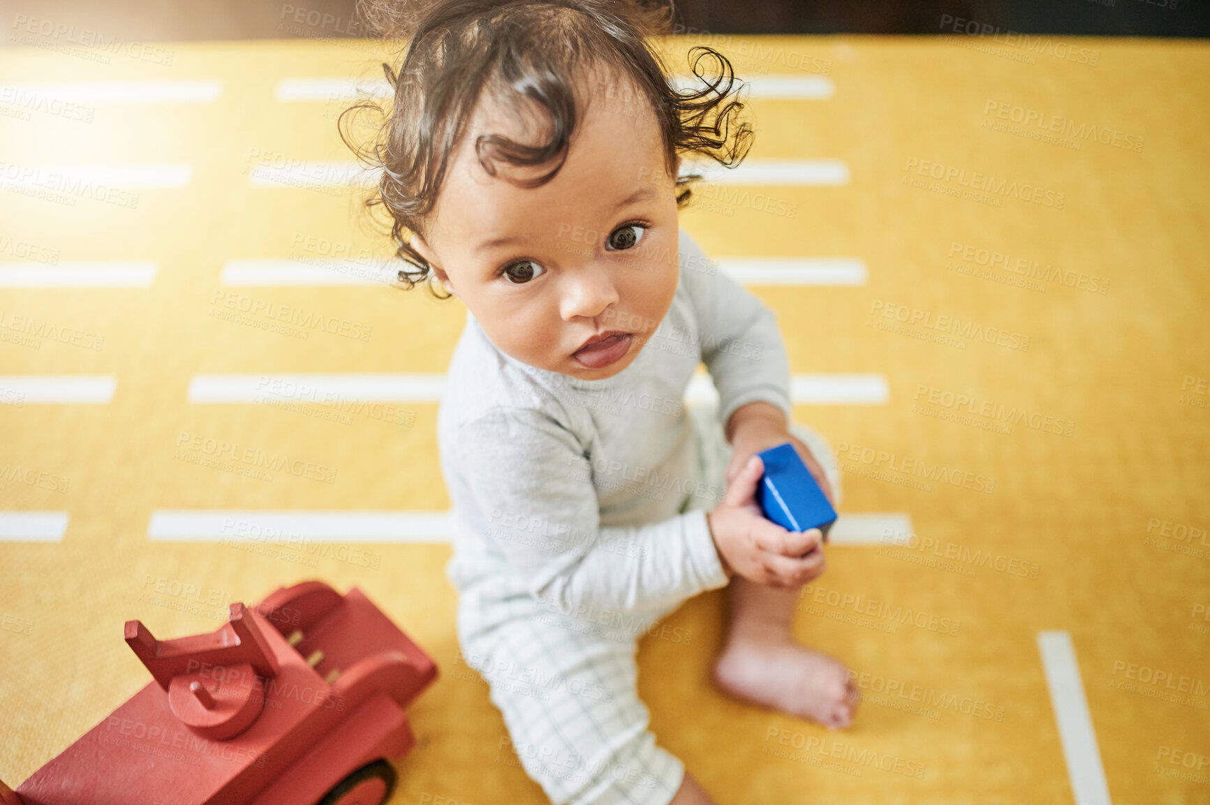 Buy stock photo Face, nursery and baby playing with toys for growth, education and child development at home. Boy, childcare and kid with toy truck, building blocks and having fun learning motor skills in bedroom