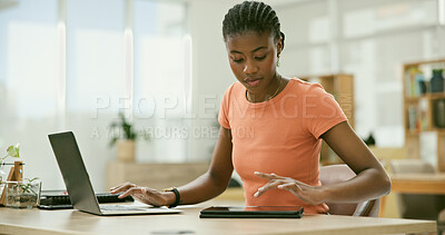 Buy stock photo Tablet, laptop and young black woman in the office doing research for creative project. Digital technology, career and professional African female designer working on computer in the modern workplace