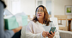 Shock, gift and senior woman in home with omg reaction for present, surprise visit and parcel. Home, retirement and person with phone, wow and unexpected for thank you, package and appreciation