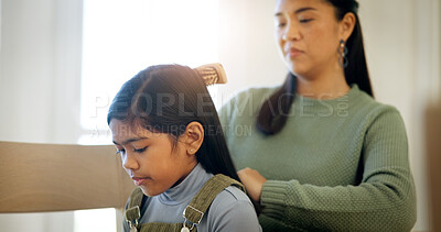 Buy stock photo Child, mother and brush for hair care in home, grooming and help daughter in morning routine. Parent, girl and hairstyle assistance with Asian family, beauty support and bonding together with love