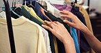 Person, hands or clothing line in shop for garment option, styling choice or rail selection. Designer, stylist or browsing fashion with colorful outfits for tailoring, dressmaking or fitting in store