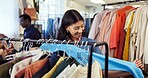 Shopping, choice and woman in store with clothing, outfit search and decision in trendy style. Retail, happy and person in boutique with apparel, garment option and selection for fashion purchase.