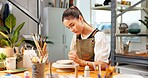 Potter, woman and painting in studio for ceramic decoration, custom design or handmade creation. Pottery, person or unique art on clay sculpture for small business order, merchandise or color pattern