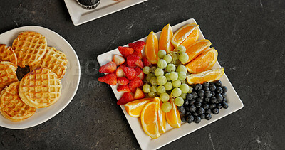 Buy stock photo Above, food and breakfast spread on table with waffles, homemade meal and colorful presentation. Fresh, nutrition and fruit platter on counter for brunch arrangement, appetizing and weekend morning