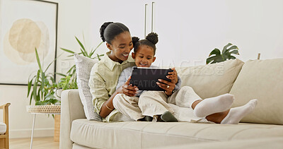 Buy stock photo Laughing, mom and child with tablet in home, love and watching cartoons with subscription in lounge. Family, bonding and black woman with daughter, happy and streaming movie with technology in house