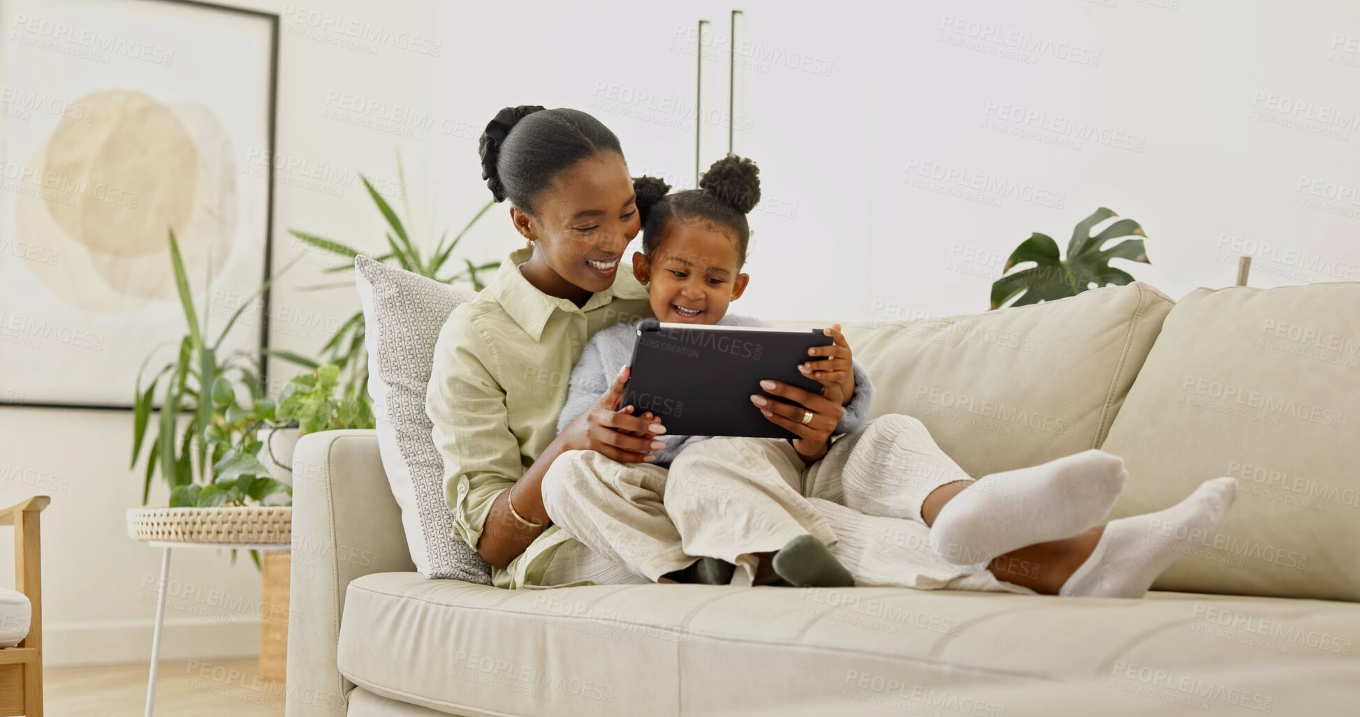Buy stock photo Laughing, mom and child with tablet in home, love and watching cartoons with subscription in lounge. Family, bonding and black woman with daughter, happy and streaming movie with technology in house