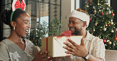 Buy stock photo Christmas, gift or black couple with surprise for festive celebration or holiday together in home. Man, woman or thank you with box, smile or present for December, Santa weekend or package in house