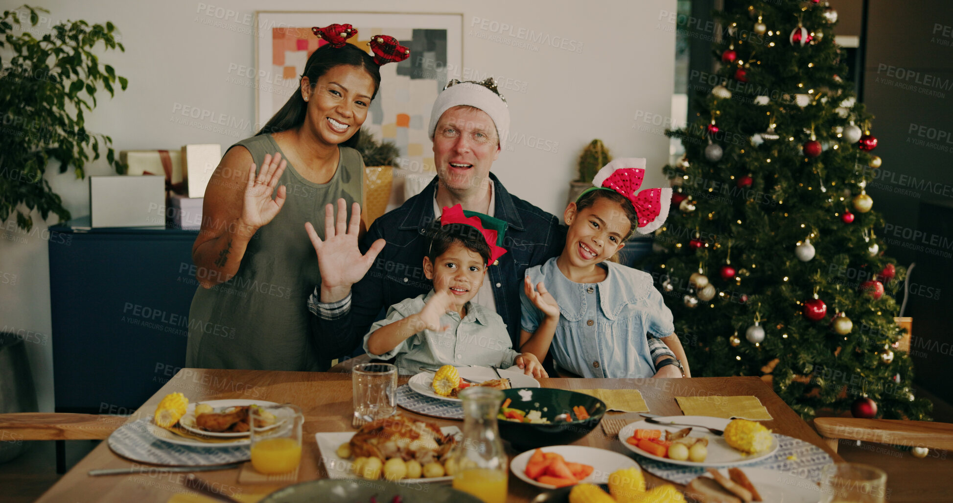 Buy stock photo Christmas, video call and family with dinner, home and waving together on festive season or bonding. Happy people, portrait and parents with kids on Xmas, interracial and greeting for virtual chat