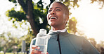 Fitness, woman and thinking with water outdoor for wellness, health or workout rest with smile. Thirsty runner, happy black person and break with hydration bottle at park, refreshing or reflection