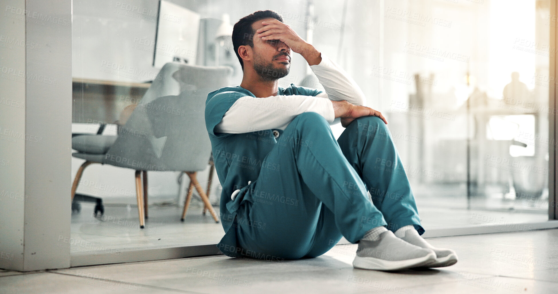 Buy stock photo Nurse, man and healthcare stress in clinic for grieving loss, operation failure and shift burnout. Health, worker and overwhelmed on hospital floor for medical crisis, emotional fatigue and pressure