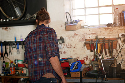 Buy stock photo Small business, back or man in repair workshop, bicycle store for fixing, maintenance or upgrade. Startup, warehouse or mechanic in garage with bike parts, mechanical engineering or transportation