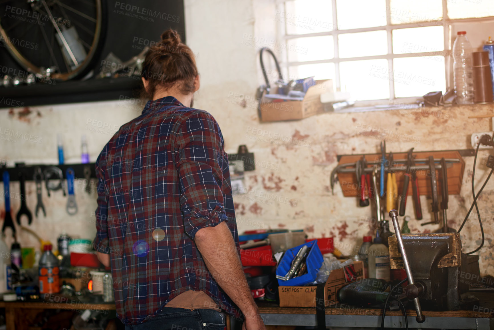 Buy stock photo Small business, back or man in repair workshop, bicycle store for fixing, maintenance or upgrade. Startup, warehouse or mechanic in garage with bike parts, mechanical engineering or transportation