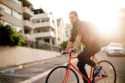 Buy stock photo Travel, adventure and man on bicycle in city for commuting, journey or carbon footprint on holiday. Street, cycling and person on bike for eco friendly transport on vacation or weekend trip in town.