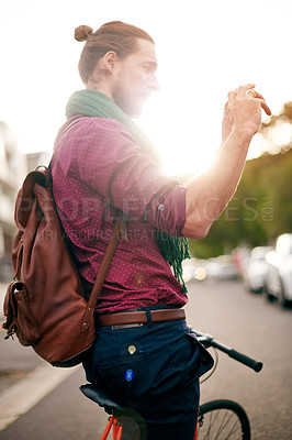 Buy stock photo Tourism, photograph or man on bicycle in street for holiday vacation or sightseeing memory. Sunrise, explore or tourist in urban town with bike for outdoor adventure, social media post or city travel