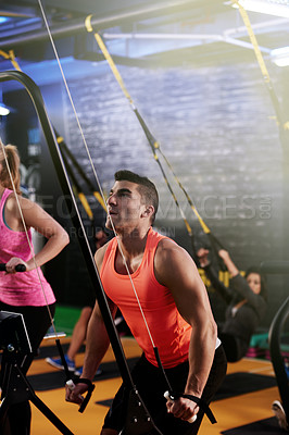 Buy stock photo Cardio, man and suspension trainer in gym for body, wellness and bodybuilding exercise. Triceps, challenge and male athlete in training class with cable equipment for muscle power, workout or fitness