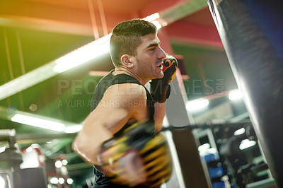Buy stock photo Boxing bag, fitness and man in gym for training, challenge or cardio activity for practice. Health, intense power and male athlete with punching equipment for performance or exercise in sports center