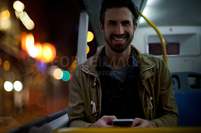 Buy stock photo Portrait, night and man with smartphone, bus and smile with social media, texting and online tram schedule. Evening, travel and happy person with cellphone, city service and public transport with app