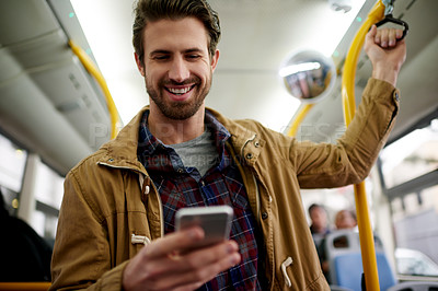 Buy stock photo Man, phone and happy in bus, travel and chat on mobile app with contact, meme and streaming video. Person, smartphone and scroll for schedule, smile and public transportation for morning commute