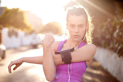 Buy stock photo Earphones, fitness and girl outdoor with stretching for running, marathon or training. Lens flare, teenager and portrait of female athlete with arm warm up for cardio workout or exercise in nature.