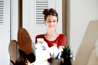 Buy stock photo Phone, portrait and happy girl relax in home for social media, blog or internet notification. Smile, mobile and teenager with feet up on table for online chat, text message or download app in house